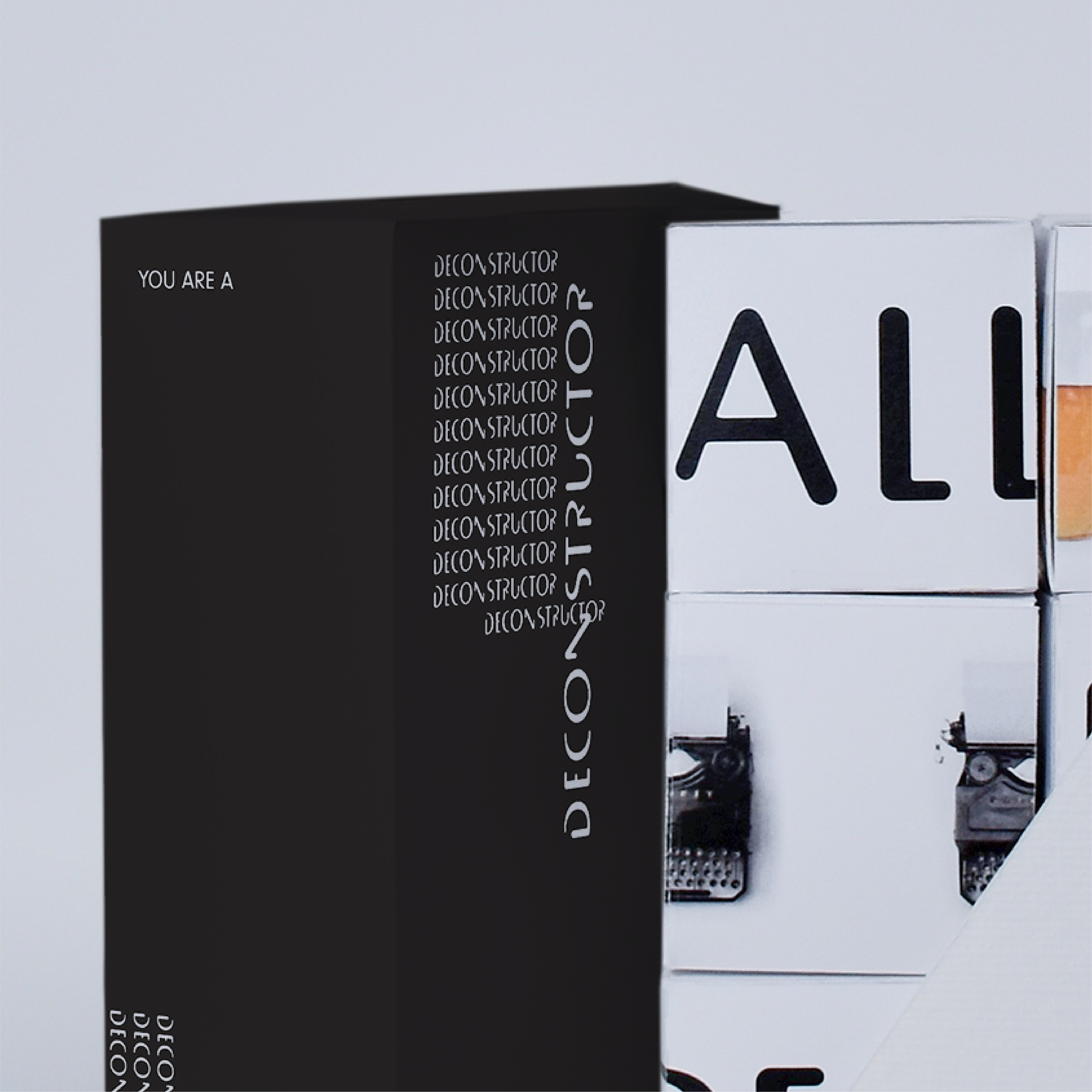 Close up of Deconstructivism game box with game pieces neatly stacked inside.